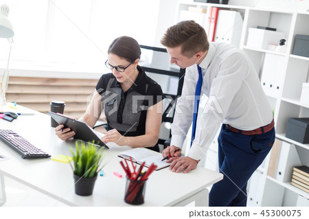 Young people working in the office with documents. Young people working in the office with documents. 45300075
