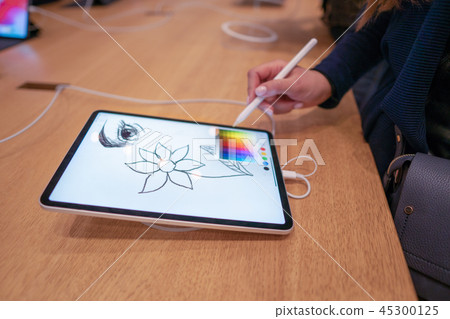 graphic designer girl drawing sketch on digital tablet screen with stylus pencil graphic designer girl drawing sketch on digital tablet screen with stylus pencil 45300125