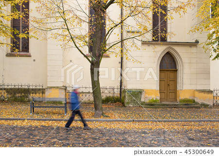 Side door of Gothic church in Zatec town. Autumn. 45300649