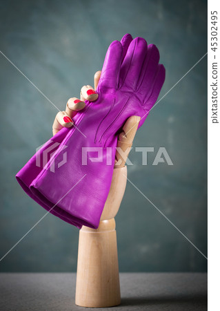 pink gloves in wooden hand 45302495