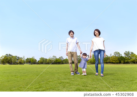 Happy young couple playing with their little daughter in the park on green grass. Affection, happiness, parent and child, family image Happy young couple playing with their little daughter in the park on green grass. Affection, happiness, parent and child, family image 45302908