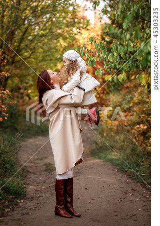 charming beautiful mother walks with little daughter girl 45303235