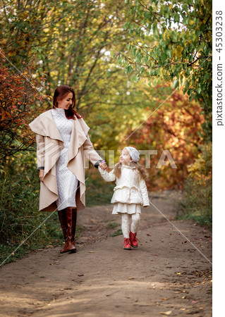 charming beautiful mother walks with little daughter girl 45303238