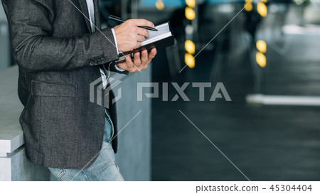 man writing info notebook records data analysis man writing info notebook records data analysis 45304404