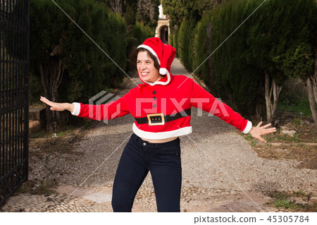 Christmas, holidays, humor and people concept - funny happy woman in santa suit dancing outdoors Christmas, holidays, humor and people concept - funny happy woman in santa suit dancing outdoors 45305784