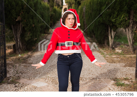 Christmas, holidays, humor and people concept - funny happy woman in santa suit dancing outdoors Christmas, holidays, humor and people concept - funny happy woman in santa suit dancing outdoors 45305796