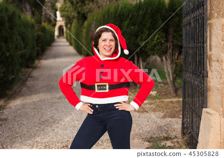 Christmas and holiday concept - Happy woman having fan in Santa Claus costume Christmas and holiday concept - Happy woman having fan in Santa Claus costume 45305828