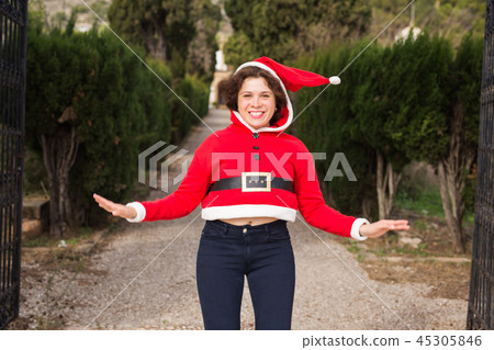 Christmas, holidays, humor and people concept - funny happy woman in santa suit dancing outdoors Christmas, holidays, humor and people concept - funny happy woman in santa suit dancing outdoors 45305846