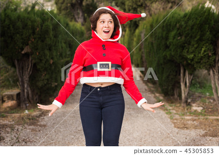 Christmas, holidays, humor and people concept - funny happy woman in santa suit dancing outdoors Christmas, holidays, humor and people concept - funny happy woman in santa suit dancing outdoors 45305853
