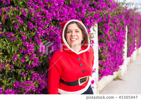 Holidays and people concept - smiling funny woman in christmas costume outdoors Holidays and people concept - smiling funny woman in christmas costume outdoors 45305947