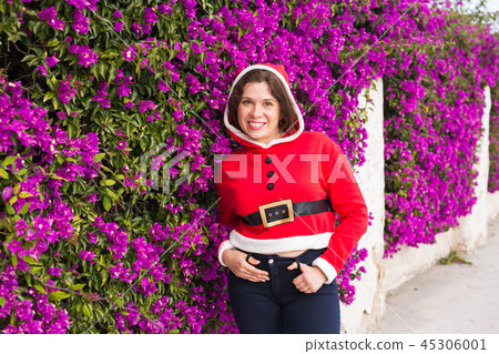 Christmas, holidays, humor and people concept - young happy woman smiling in christmas suit at Christmas, holidays, humor and people concept - young happy woman smiling in christmas suit at 45306001