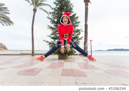 people, holidays and christmas concept - young funny and expressive woman dressed as santa claus people, holidays and christmas concept - young funny and expressive woman dressed as santa claus 45306294