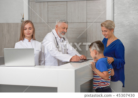 Mother and son looking at analysis in hospital. Mother and son looking at analysis in hospital. 45307430