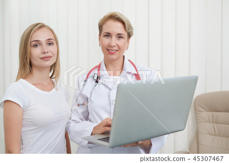 Female patient and doctor posing together. Female patient and doctor posing together. 45307467