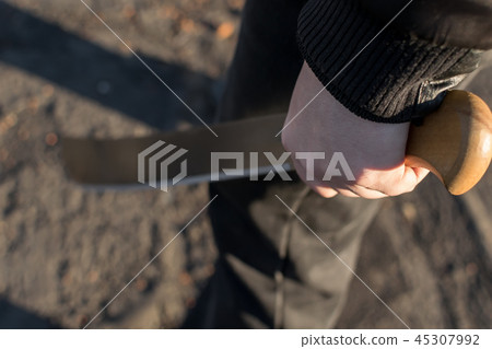 machete in the hand of a man machete in the hand of a man 45307992