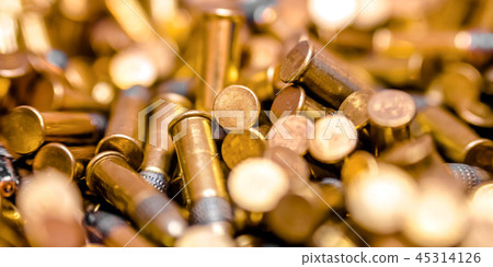 Close up of shiny bullets in a pile 45314126