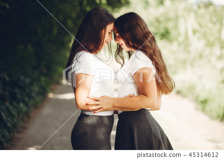 Cute sisters in a park Cute sisters in a park 45314612