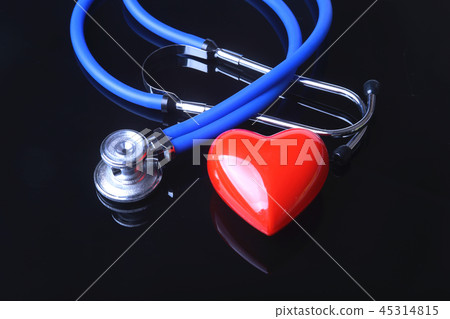 stethoscope, Red heart and blood pressure meter on black mirror background. Selective focus. 45314815
