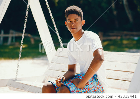 Black guy in a summer park Black guy in a summer park 45315441