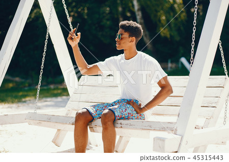 Black guy in a summer park Black guy in a summer park 45315443