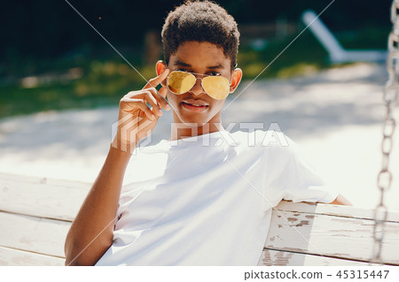 Black guy in a summer park Black guy in a summer park 45315447
