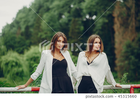 Fashion girls in a park Fashion girls in a park 45315660