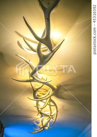 Antler deer light fixture in hotel lobby hallway Antler deer light fixture in hotel lobby hallway 45316392