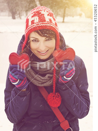 Young woman with two hearts in the hands 45320652
