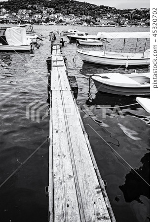Wooden pier with boats in harbor, Trogir, Croatia 45320702