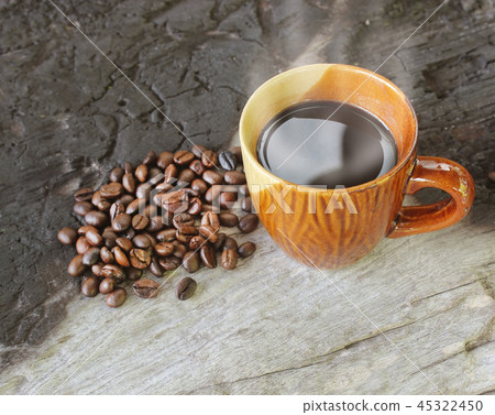 Coffee cup and coffee beans on old wood 45322450