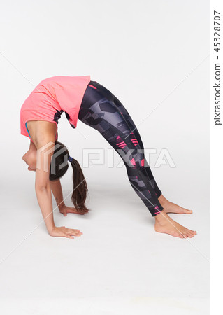 Woman practicing yoga Bridge pose 45328707
