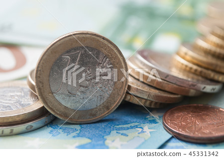 closeup of coins piles and banknote in euro money 45331342