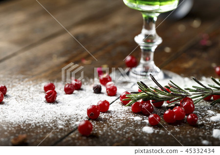 snow and cranberries near the glass 45332434