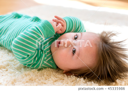 Baby boy lying down Baby boy lying down 45335986