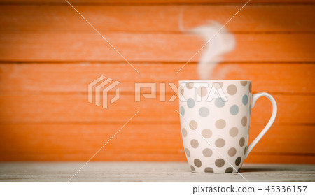 Tea or coffee cup on wooden table. Tea or coffee cup on wooden table. 45336157