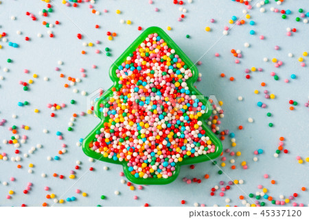Christmas tree shaped cookie with sprinkles. Christmas tree shaped cookie with sprinkles. 45337120