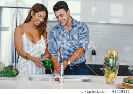 pretty couple in a kitchen pretty couple in a kitchen 45339511