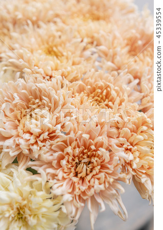 chrysanthemum yellow and pink pastel colors. bouquet in glass vase. concept of flower shop. 45339554