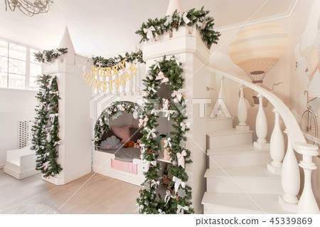 Christmas morning. Interior of a spacious children's room. decorative castle with bed inside, game 45339869