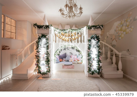 Christmas evening. Interior of a spacious children's room. decorative castle with bed inside, game 45339979