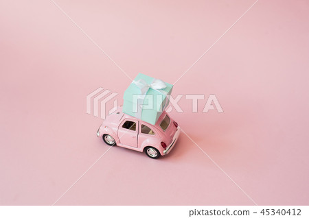 Pink toy  retro model car delivering gift box  45340412