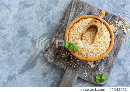 Raw organic quinoa seeds in a wooden bowl. Raw organic quinoa seeds in a wooden bowl. 45342082