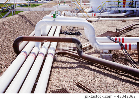 pipes and valves at oil refinery 45342362