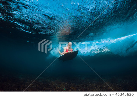 Surfer woman in bikini with surfboard underwater 45343620