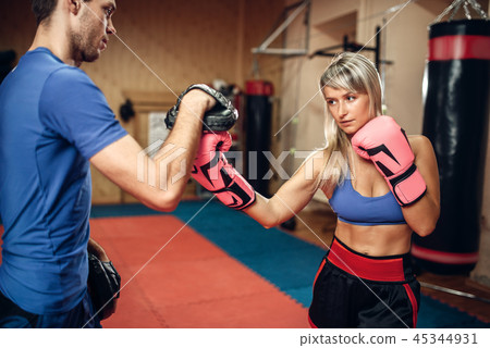 Female kickboxer practicing hand punch Female kickboxer practicing hand punch 45344931
