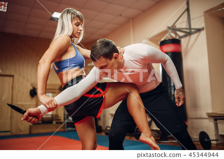 Female person practicing knee kick to the stomach Female person practicing knee kick to the stomach 45344944