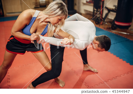 Woman makes elbow kick, self-defense workout Woman makes elbow kick, self-defense workout 45344947