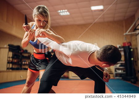 Woman makes elbow kick, self-defense workout Woman makes elbow kick, self-defense workout 45344949