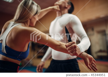 Woman makes punch to the throat, self-defense Woman makes punch to the throat, self-defense 45344951