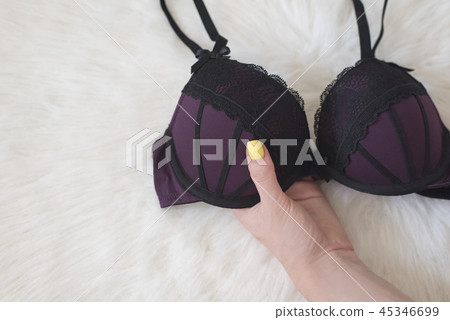 Fashionable concept. Black lace bodice on fur Fashionable concept. Black lace bodice on fur 45346699